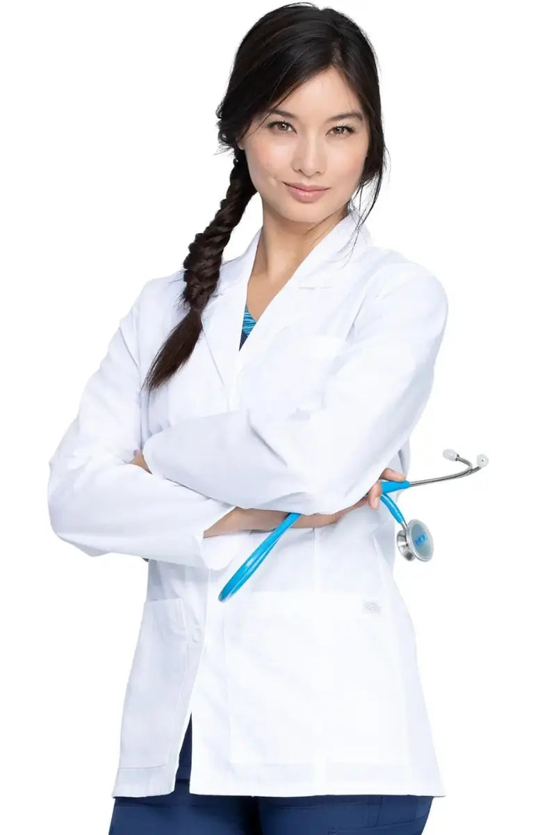 A young female Surgeon wearing a Dickies Women's EDS Signature Lab Coat in White size Small featuring two lower front patch pockets.