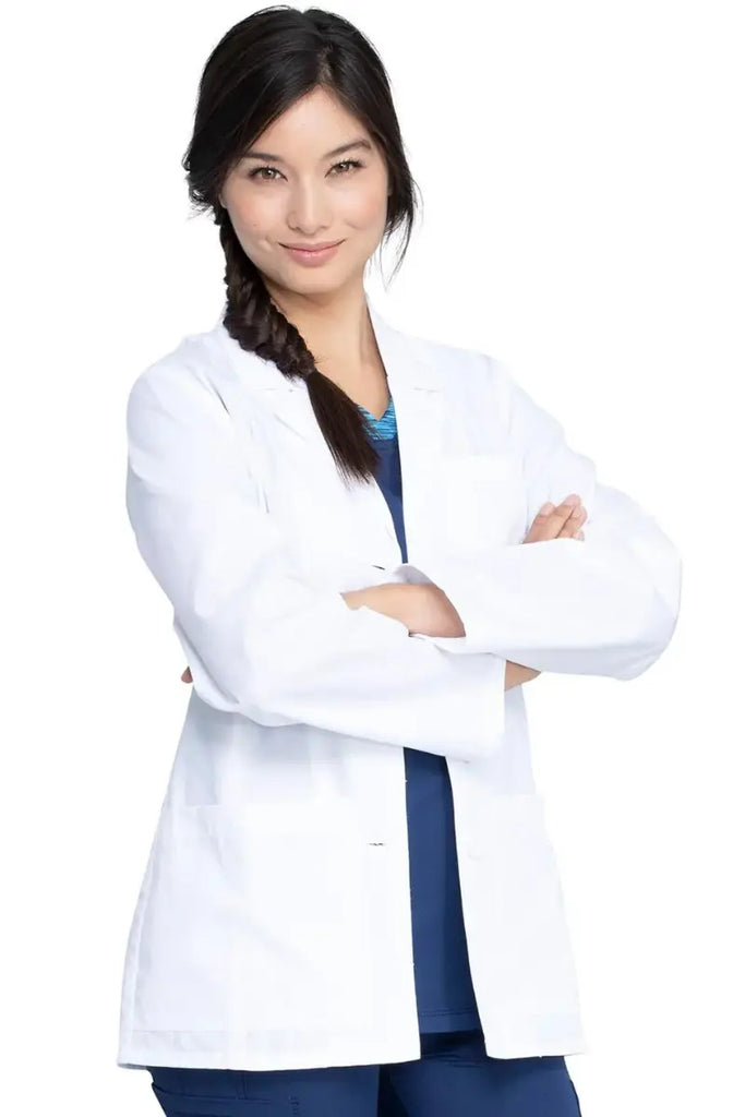 A young female Lab Technician wearing a Dickies Women's EDS Signature 28" Lab Coat in White featuring a notched lapel.