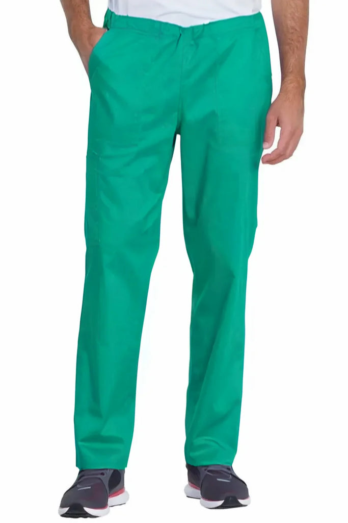 A young male Surgeon wearing a pair of the Dickies Industrial Unisex Mid-Rise scrub Pants in Surgical Green featuring a straight leg design offers unrestricted movement all day long.