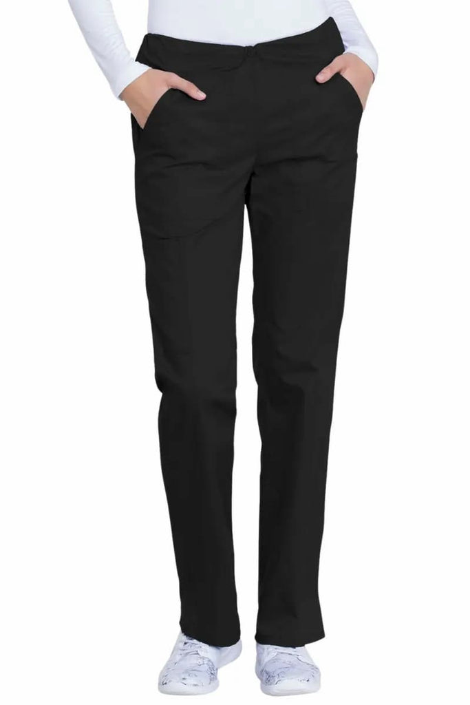 A young female EMT wearing a pair of Dickies Industrial Women's Drawstring Scrub Pants in Black size Small Petite featuring a flattering, Modern Classic Fit allowing the wearer ease of movement all day long.