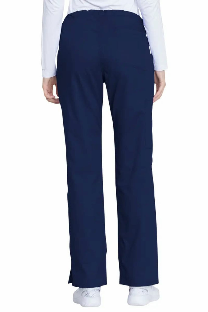 A female Registered Nurse (RN) showcasing the back of the Dickies Industrial Women's Drawstring Scrub Pants in Navy Blue size Large Tall featuring an inseam of 34.5".