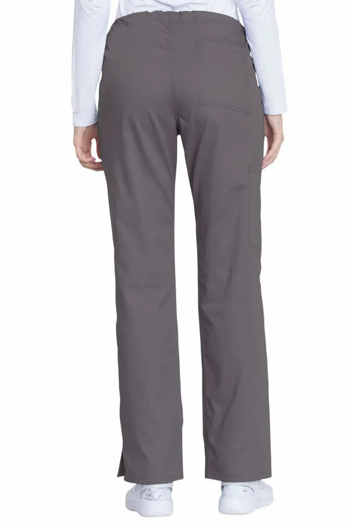 A female Pharmacy tech showcasing the back of the Dickies Industrial Women's Drawstring Scrub Pants in Pewter size 3XL featuring a modern classic fit that offers a professional look while allowing for ease of movement.