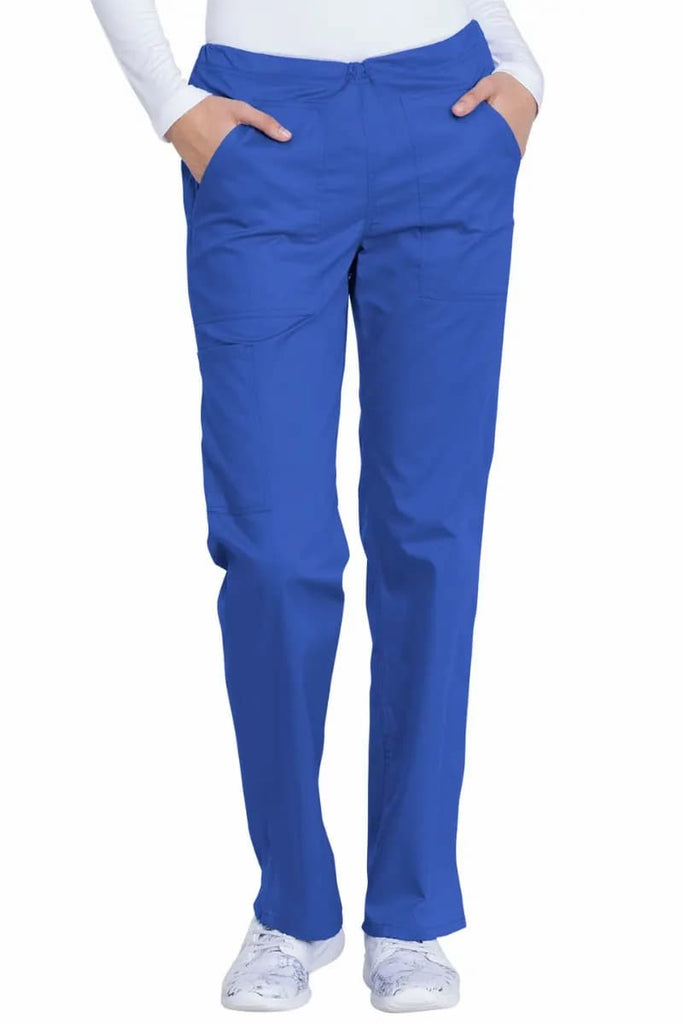 A young female Physical Therapist wearing a Dickies Industrial Women's Drawstring Scrub Pant in Royal Blue size Medium Petite featuring two front patch pockets for daily, on the job storage needs.