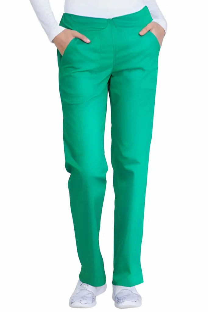 A young female Surgeon wearing a pair of the Dickies Industrial Women's Drawstring Scrub Pant in Surgical Green size Small Tall featuring a total of 4 pockets for ample storage space on the go.