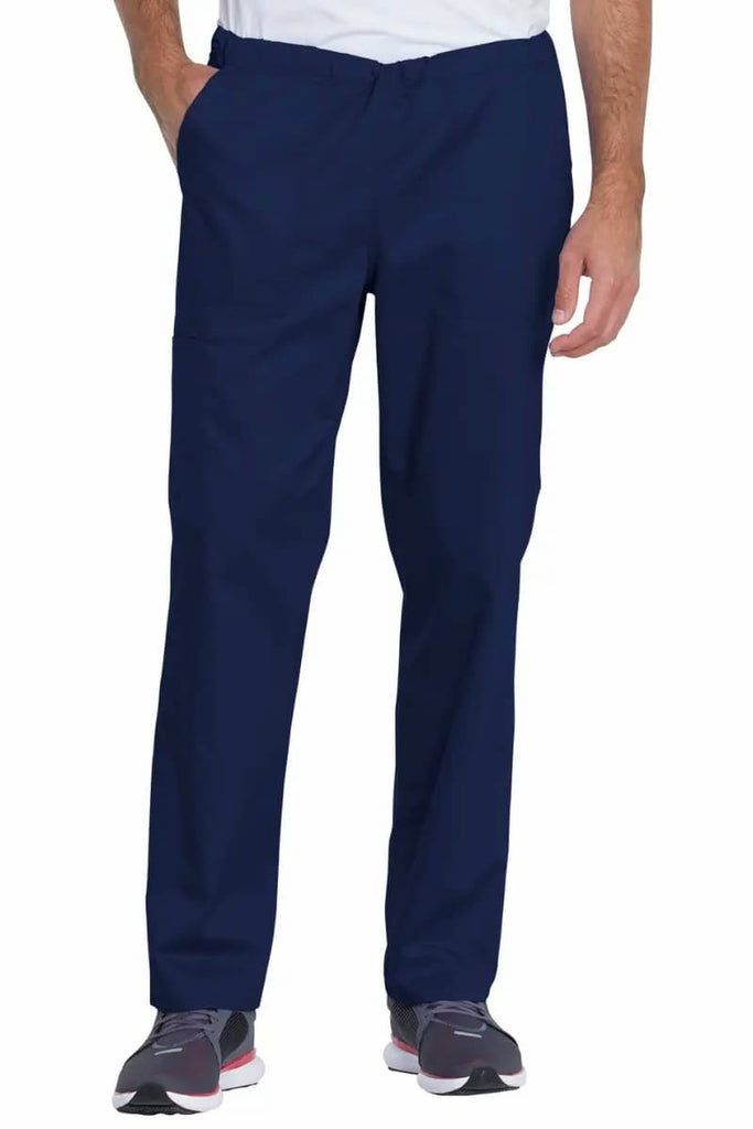 A male nurse showcasing the Dickies Industrial Mid-Rise Scrub Pant in Navy Blue featuring a wrinkle resistant fabric.