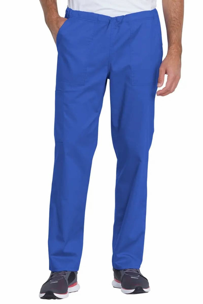 A young male Physical Therapist wearing a Dickies Industrial Unisex Mid-Rise Scrub Pant in Royal Blue featuring a total of 4 pockets for ample storage space.