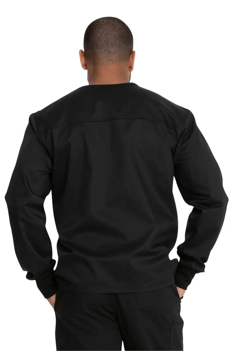 A young male Nurse showcasing the back of the Dickies Unisex Warm-Up Scrub Jacket in Black featuring a flattering silhouette for all body types. 