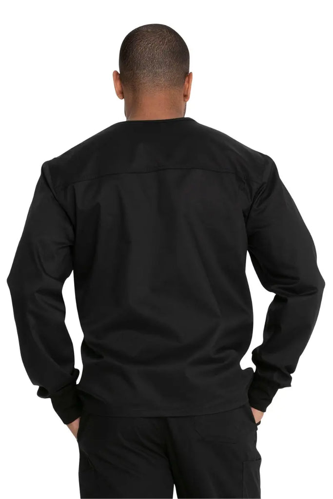 A young male Nurse showcasing the back of the Dickies Unisex Warm-Up Scrub Jacket in Black featuring a flattering silhouette for all body types. 