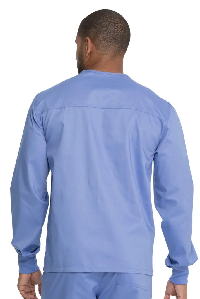A young male Medical Student showcasing the back of the Dickies Unisex Warm-Up Scrub Jacket in Ceil Blue featuring a flattering silhouette for all body types.