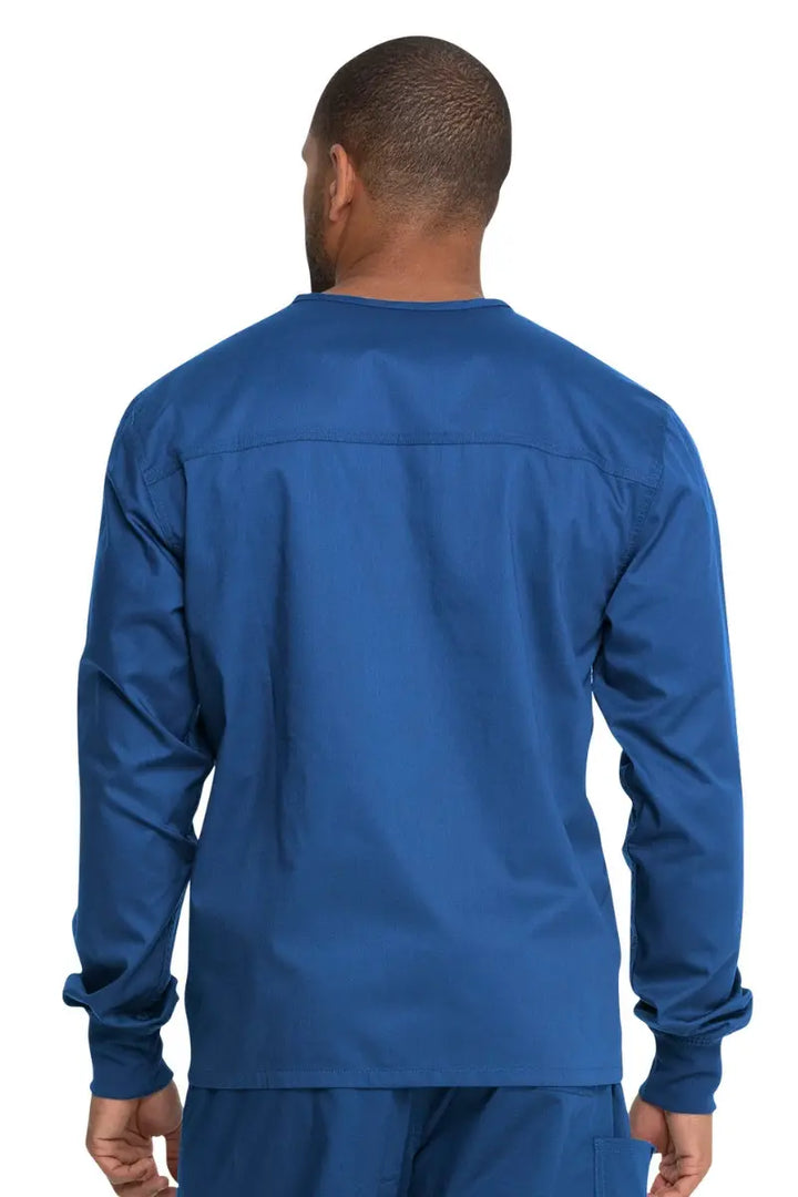 A young male Obstetric Medical Assistant showcasing the back of the Dickies Unisex Warm-Up Scrub Jacket in Royal Blue featuring a flattering silhouette for all body types.