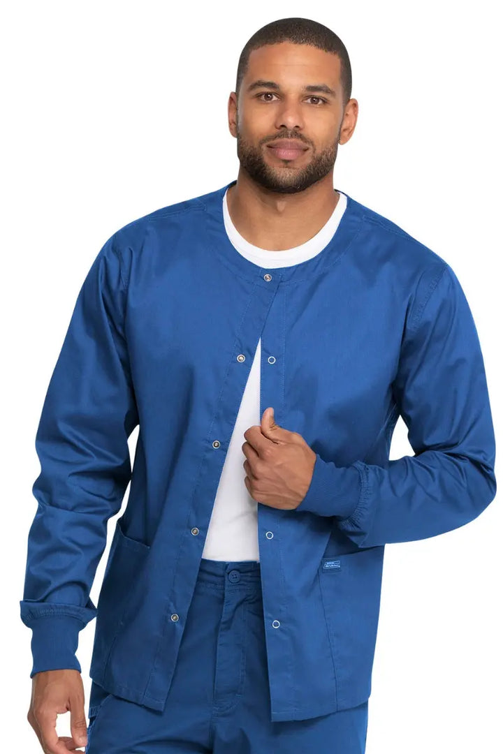 A young male Administrative Medical Assistant wearing a Dickies Industrial Unisex Warm-Up Jacket in Royal Blue size 5XL featuring an easy care fabric made to withstand industrial laundering.