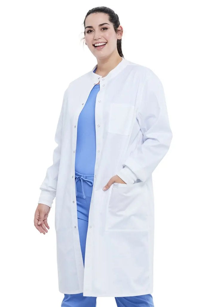 A young female Lab Technician wearing a Dickies Industrial Unisex Snap Front Lab Coat in White size 2XL featuring a total of 3 pockets.