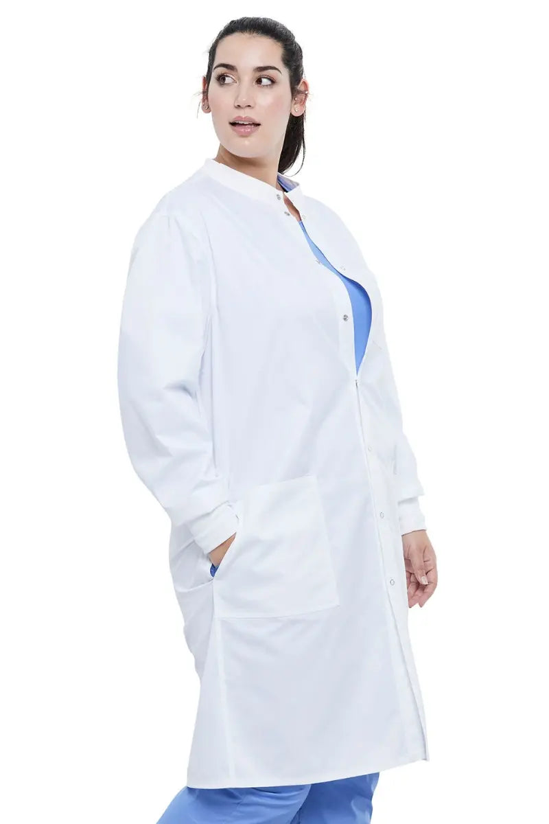 A young female Microbiologist wearing a Dickies Industrial Unisex Snap Front Lab Coat in White size 5XL featuring side slits for additional range of motion.