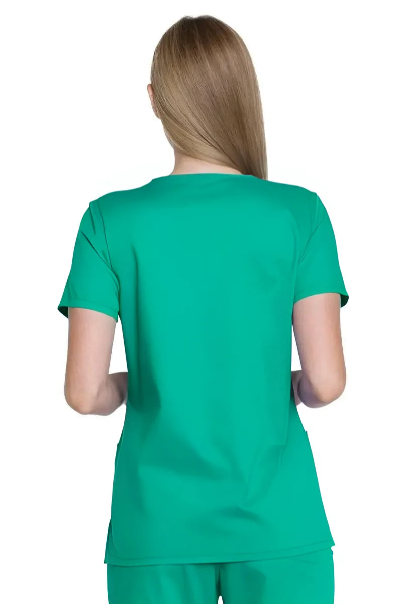 A young female Surgeon showcasing the back of the Dickies Industrial Women's V-Neck Scrub Top in Surgical Green size Medium featuring a center back length of 26".