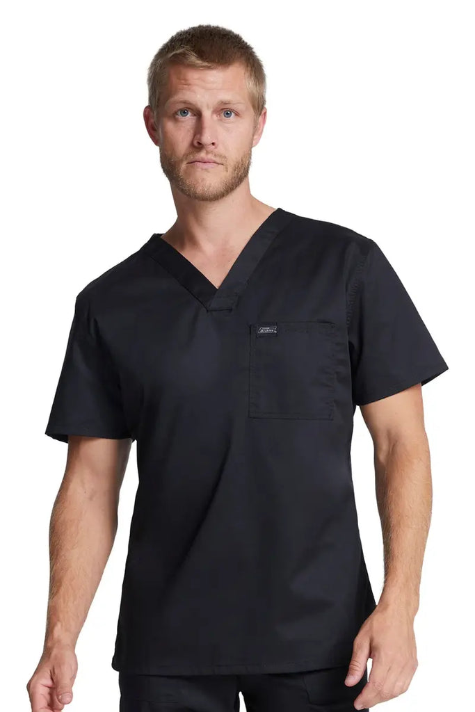 A young male EMT wearing a Dickies Industrial Unisex Tuckable V-Neck Scrub Top in Black size 2XL featuring a conveniently placed chest pocket for easy access to essentials.
