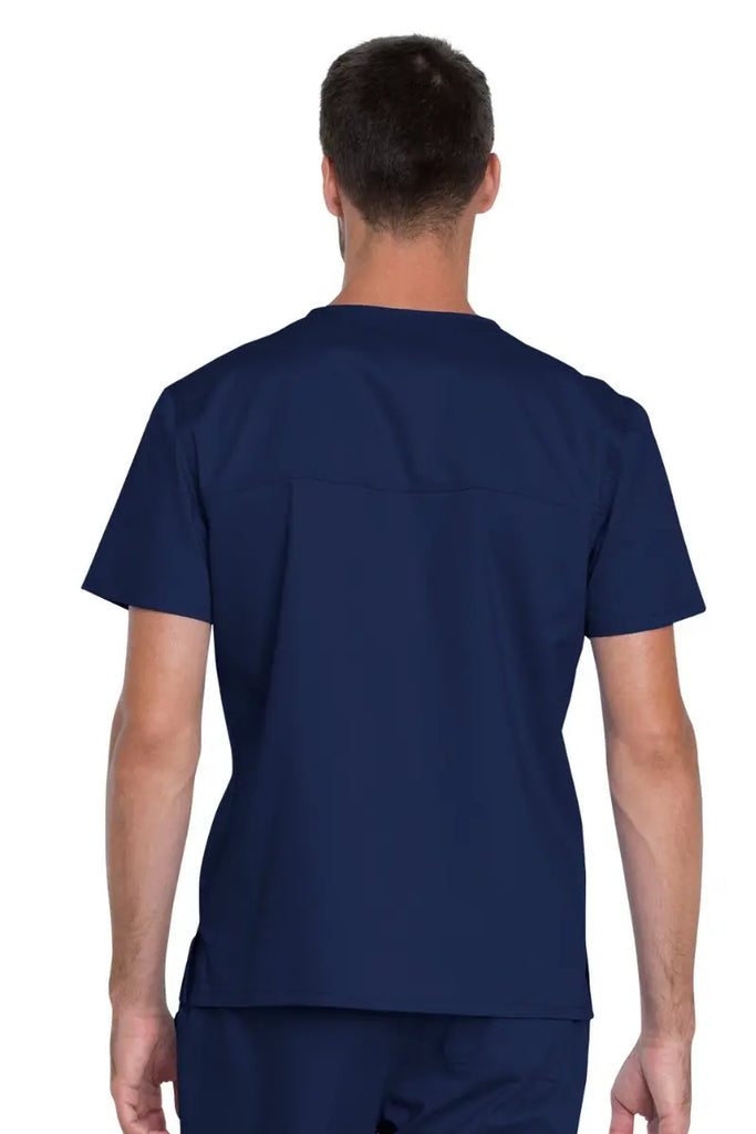 The back of the Dickies Industrial Unisex Tuckable V-Neck Scrub Top in Navy Blue featuring a back yoke to ensure a flattering fit for various body types.