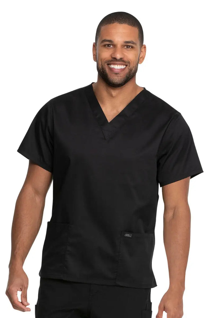 A young male Medical Specialist wearing a Dickies Industrial Unisex V-Neck Scrub Top in Black size 5XL featuring a soft and breathable fabric that offers all-day comfort. 