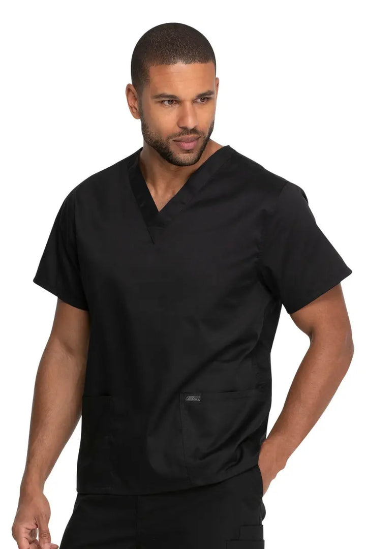 A young male EMT wearing a Dickies Industrial Unisex V-Neck Scrub Top in Black size 2XL featuring two front patch pockets.