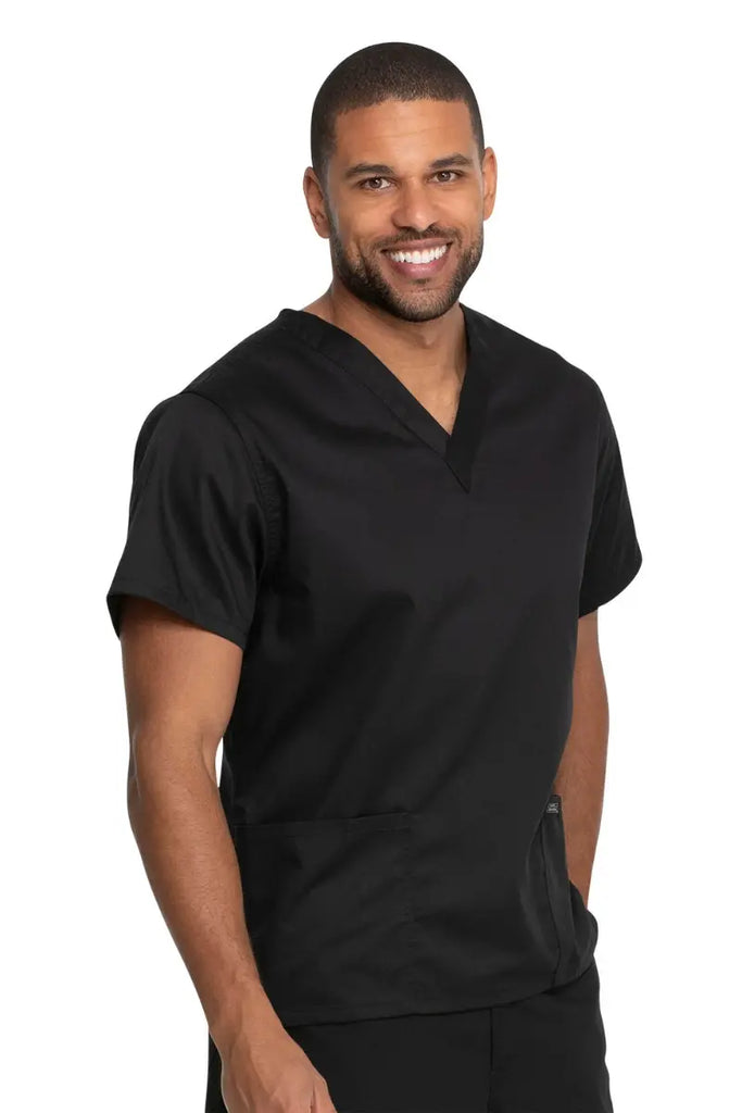 A male surgical specialist wearing a Dickies Industrial Unisex V-Neck Scrub Top in Black size 4XL featuring reinforced seams at stress points to provide extra strength and prevent tearing.