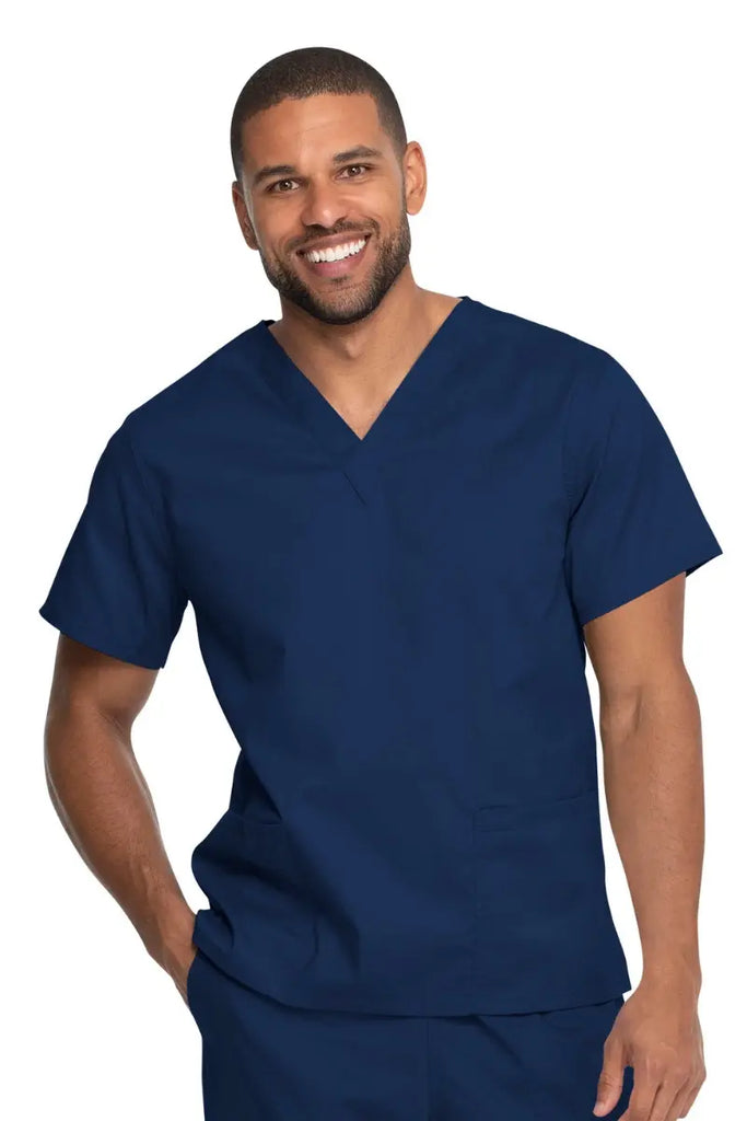 A young male CNA wearing a Dickies Industrial Unisex V-Neck Scrub Top in Navy Blue size 5XL featuring a soft and breathable fabric that offers all-day comfort.