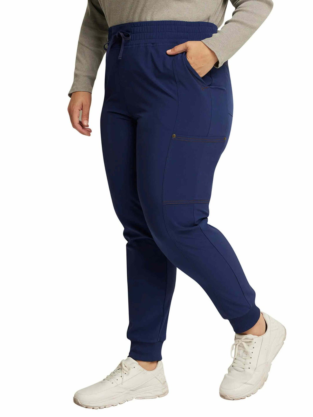 The left side of the Dickies Riveting Women's Mid Rise Scrub Jogger in Navy Blue featuring contrast copper stitching throughout.