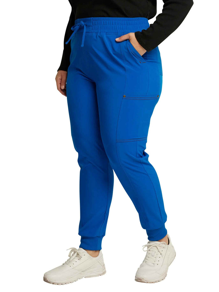 The left side of the Dickies Riveting Women's Mid Rise Scrub Joggers in Royal Blue size 4XL featuring stylish seaming throughout.