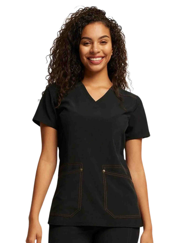 A young female EMT wearing a Dickies Riveting Women's V-neck Scrub Top in Black size XS featuring short sleeves.