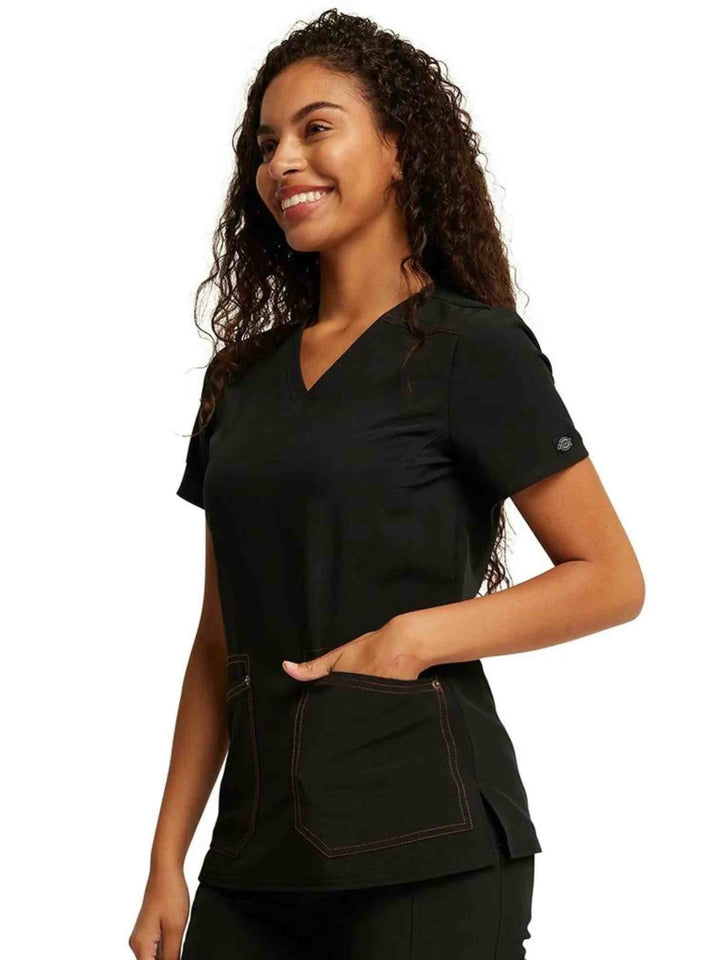 The left side of the Dickies Riveting Women's V-neck Scrub Top in Black size Small featuring a side slits and stylish seaming throughout.