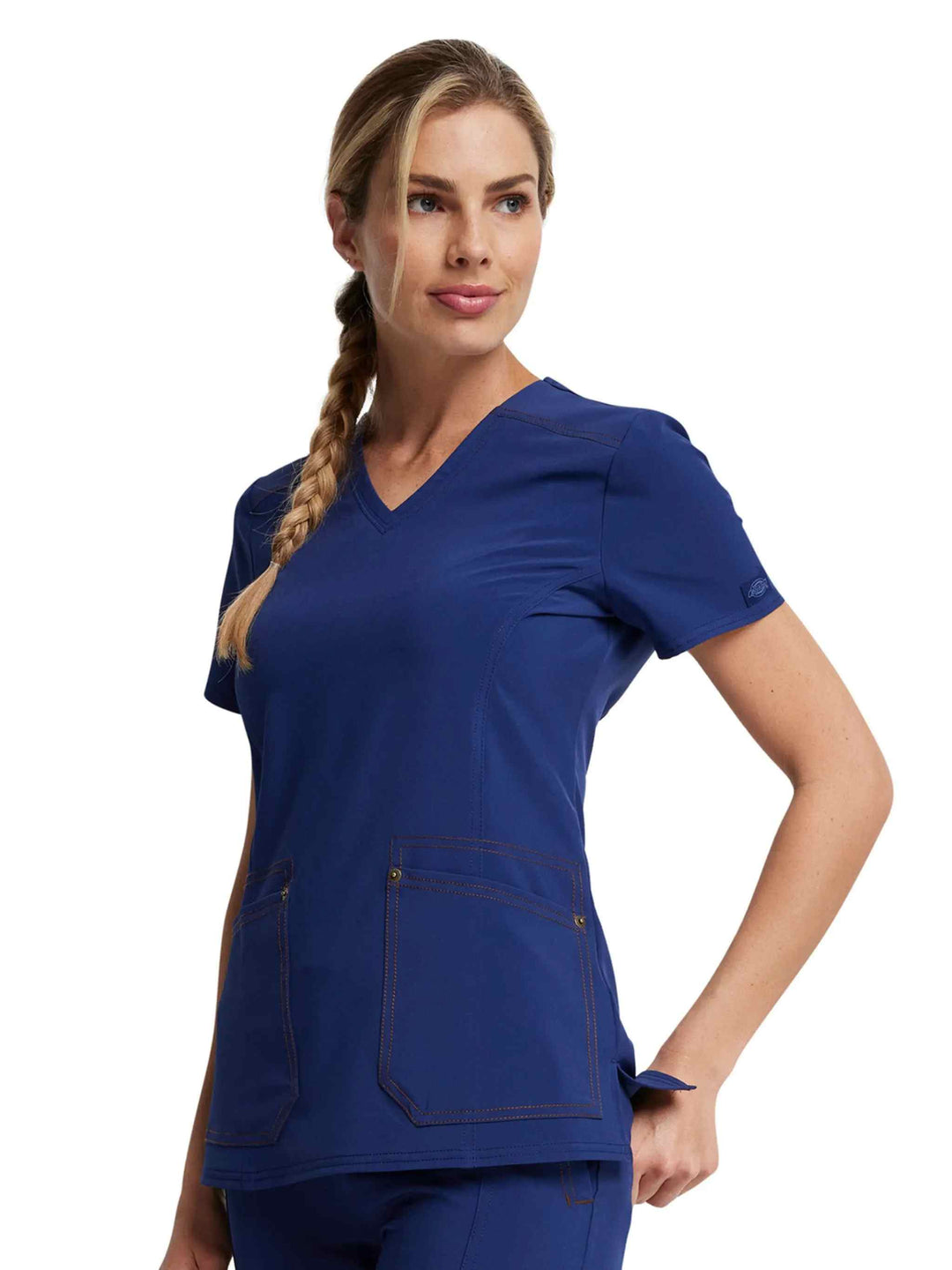 A look at the left side of the Dickies Riveting Women's V-neck Scrub Top in Navy Blue featuring two front patch pockets.