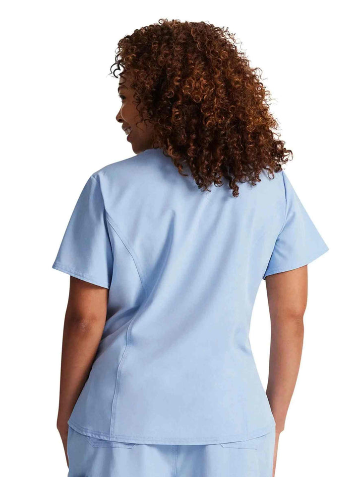 The back of the Dickies Riveting Women's Tuckable V-neck Scrub Top in Light Chambray featuring a center back length of 26.75".