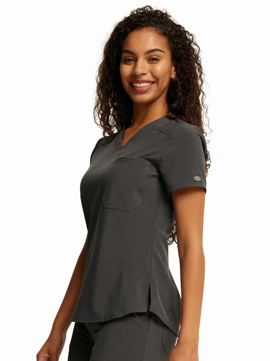 A look at the side of the Dickies Riveting Women's Tuckable V-Neck Scrub Top in Pewter size Large featuring logo rivets at the sleeves.