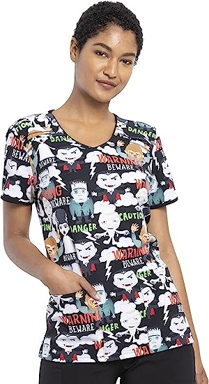 A young female LPN wearing a Cherokee Tooniforms Women's V-neck Scrub in "Beware of Monsters" in size 2XL featuring a stylish v-neckline.