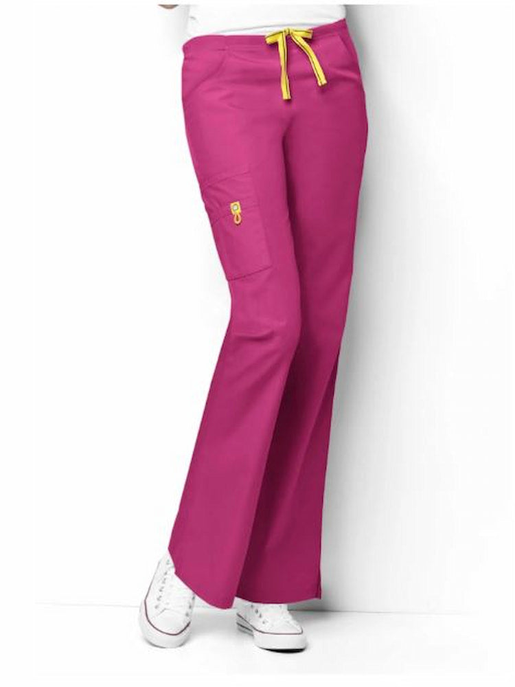 A middle aged female Pediatric Nurse wearing a WonderWink Origins Women's Romeo Cargo Scrub Pant in Hot Pink size 3XL featuring 1 right inner yellow mesh pocket.