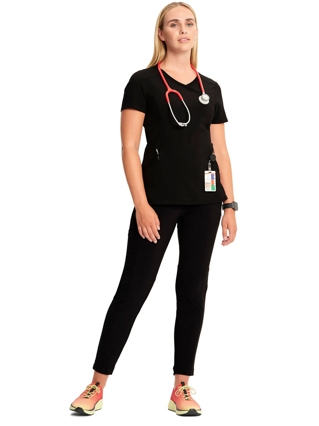 A look at a nurse wearing an Infinity Mock Wrap Scrub Top and an Infinity Women's Mid-Rise Scrub Jogger in Black on a white background.