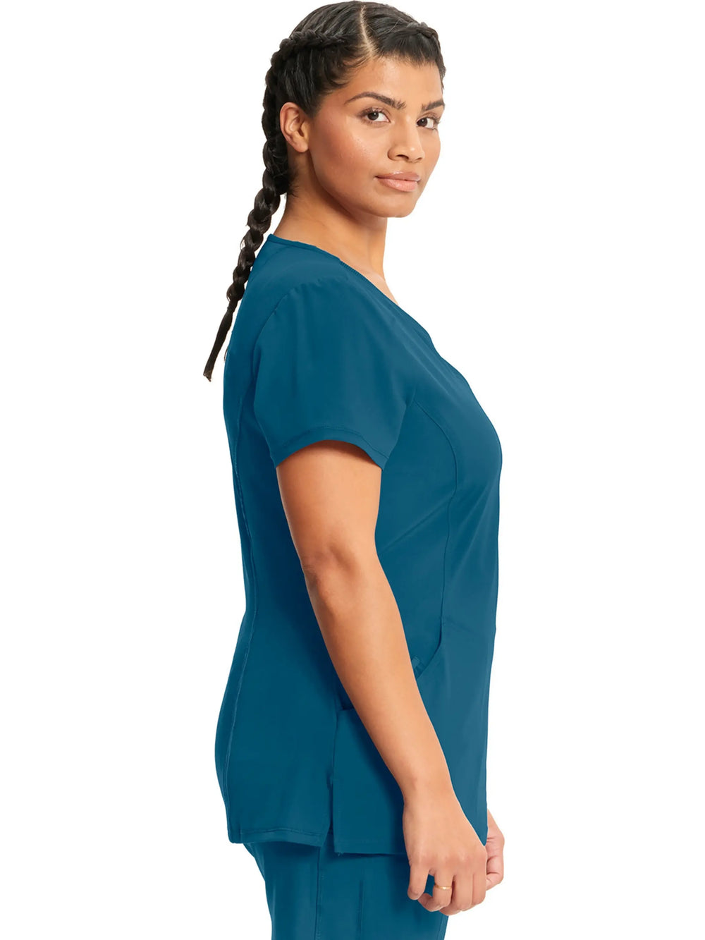 A look at the right side of the Infinity Women's Antimicrobial Mock Wrap Scrub Top in Caribbean Blue featuring side slits.