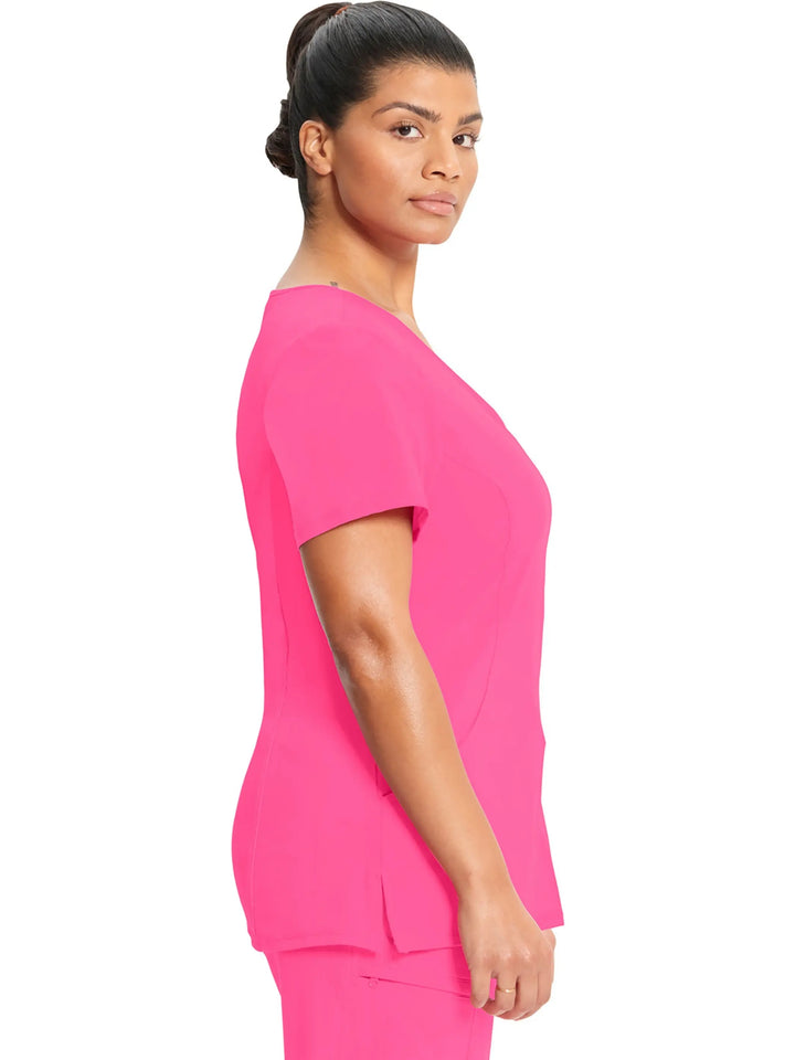 A look at the side of the Infinity Women's Mock Wrap Scrub Top (2625A) in Carmine Pink featuring short sleeves and side slits.