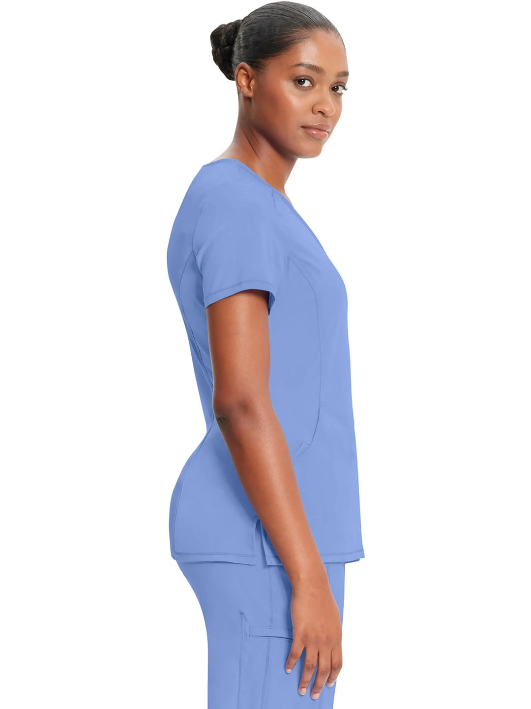 A look at the right side of the Infinity Women's Antimicrobial Mock Wrap Scrub Top in Ceil Blue featuring side slits and short sleeves.