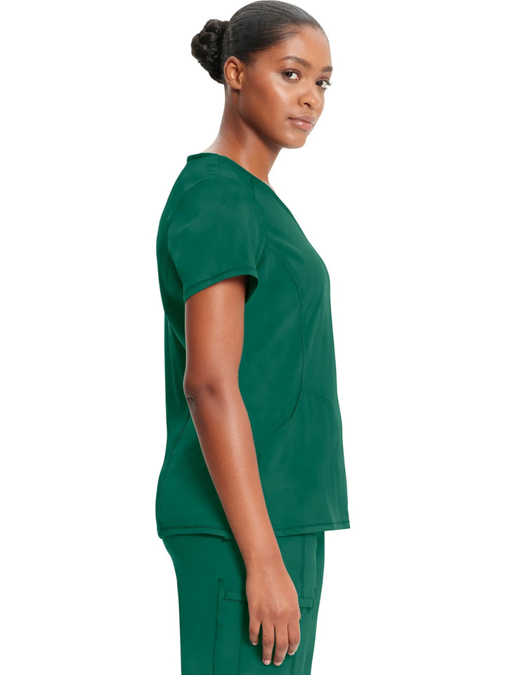 A look at the side of the Infinity Women's Mock Wrap Scrub Top (2625A) in Hunter Green featuring short sleeves and side slits.