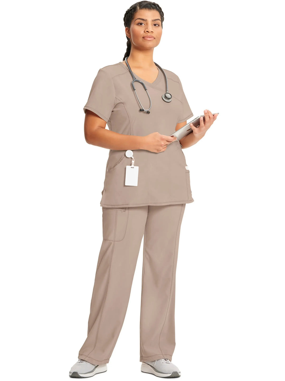 A look at a nurse wearing an Infinity Mock Wrap Scrub Top and an Infinity Women's Mid-Rise Scrub Jogger in Khaki on a white background.