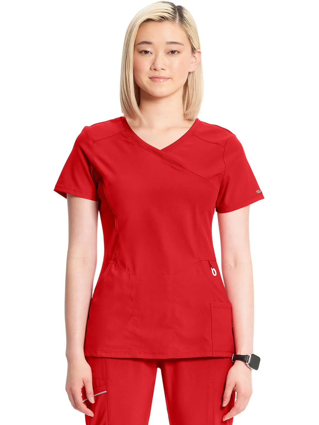 A young female Cardiologist displaying the front of the Infinity Women's Mock Wrap Antimicrobial Scrub Top in Red on a white background.