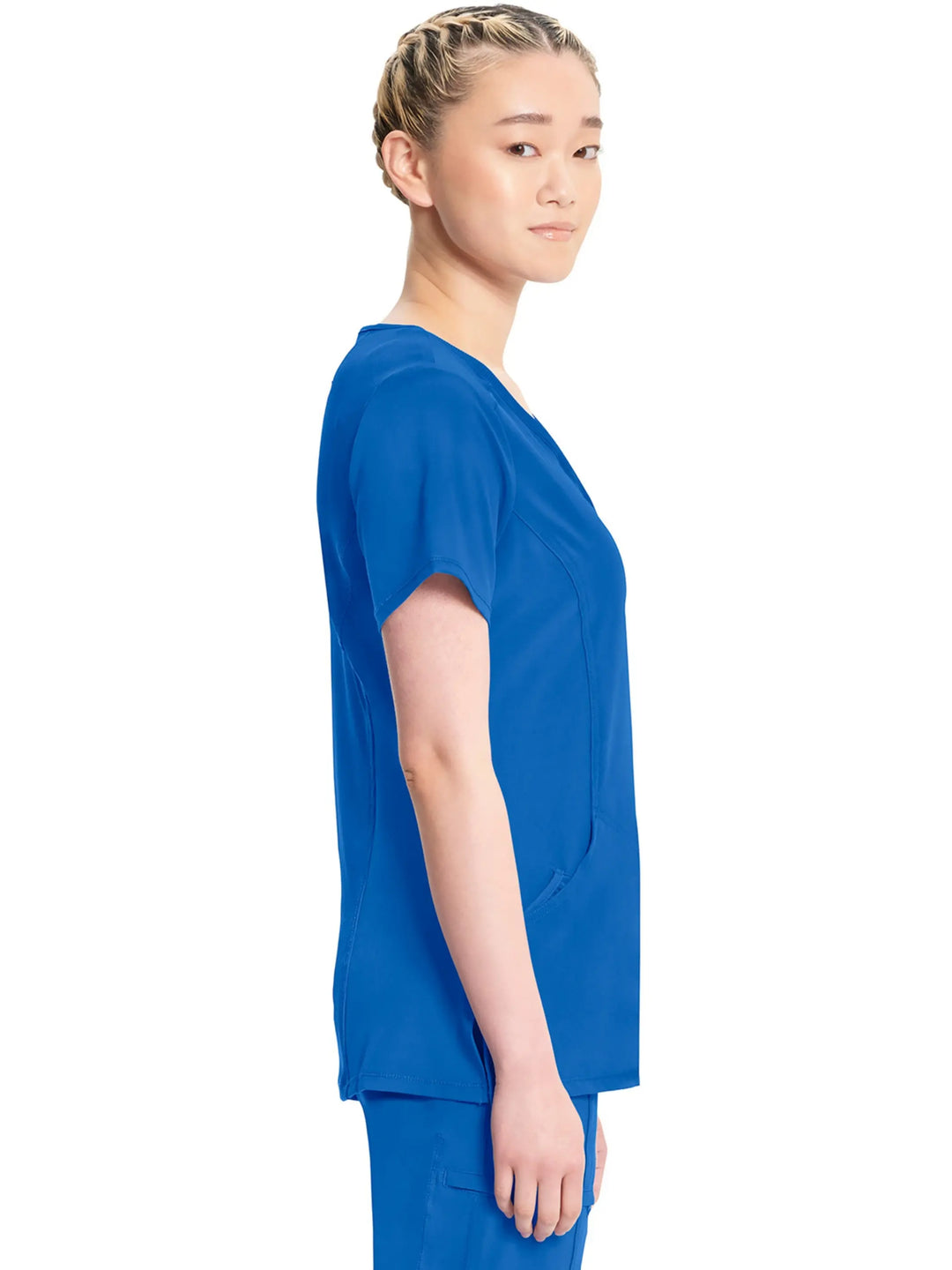 A look at the right side of the Infinity Women's Antimicrobial Mock Wrap Scrub Top in Royal Blue featuring side slits and a total of three pockets.