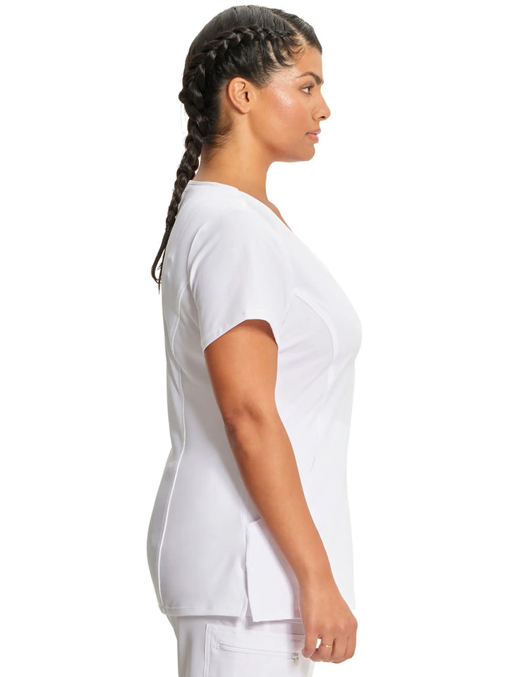 A look at the right side of the Infinity Women's Antimicrobial Mock Wrap Scrub Top in White featuring side slits and short sleeves.