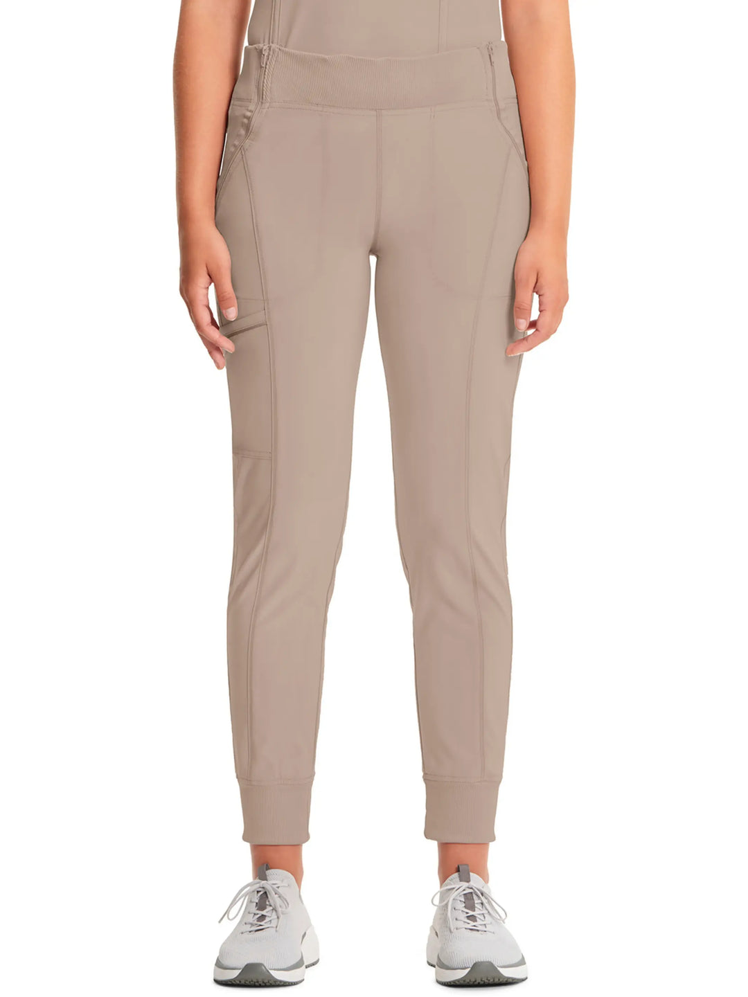 A look at the front of the Infinity Women's Mid-Rise Tapered Jogger Scrub Pant in Khaki featuring a rib knit elastic waistband.