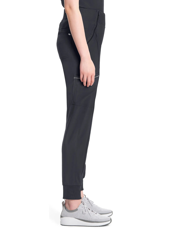 A look at the side of the Infinity Women's Mid-Rise Tapered Scrub Jogger in Pewter size medium featuring a cargo zipper pocket on the wearer's right side. 