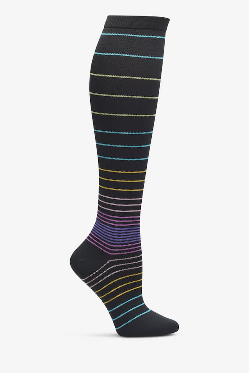 A look at the NurseMates Women's Wide Calf Compression Sock in Ombre Stripes featuring multi-colored stripes on a solid black background.