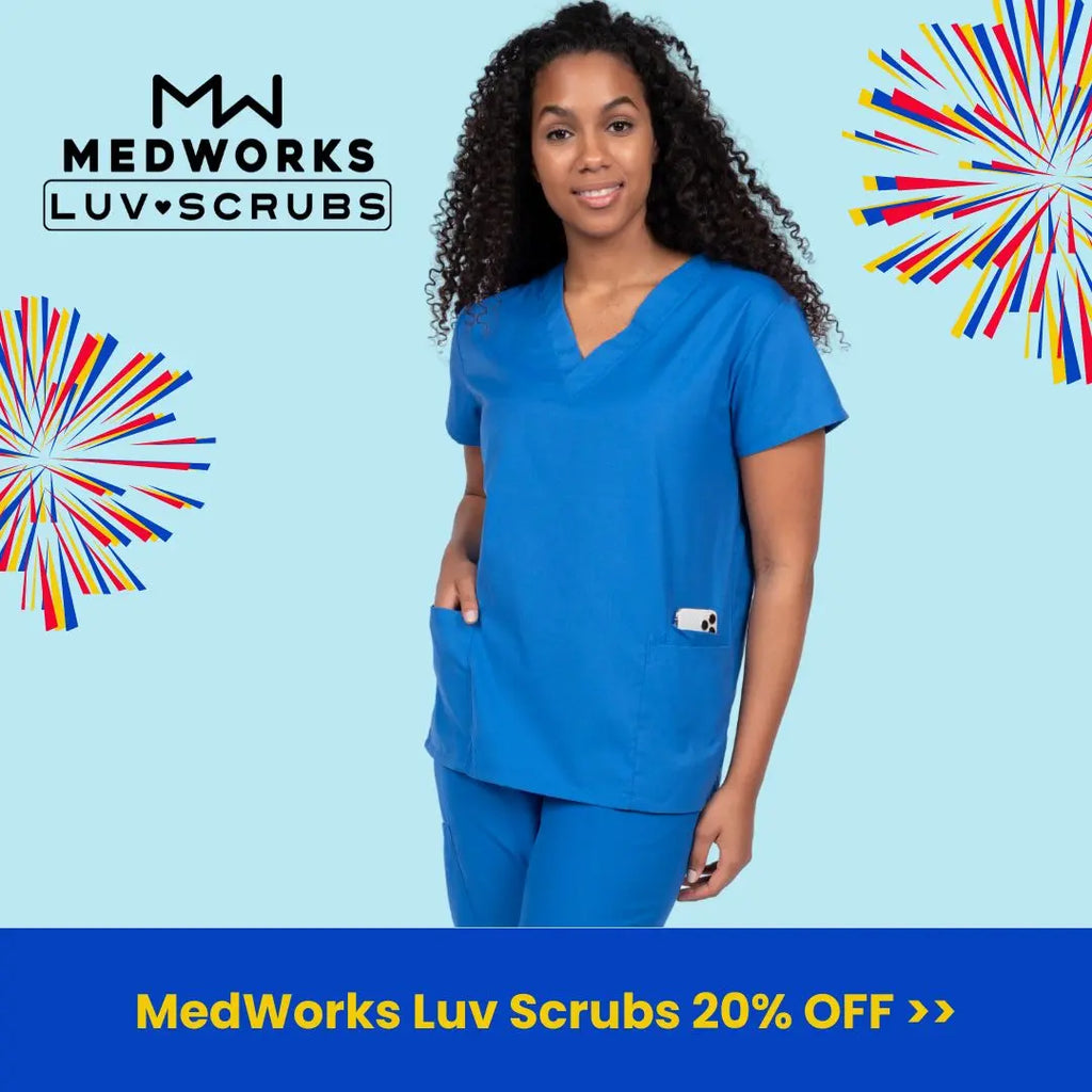 A young female Physical Therapist wearing Royal Blue scrubs on a light blue background. MedWorks Luv Scrubs are 20% off at Scrub Pro Uniforms.