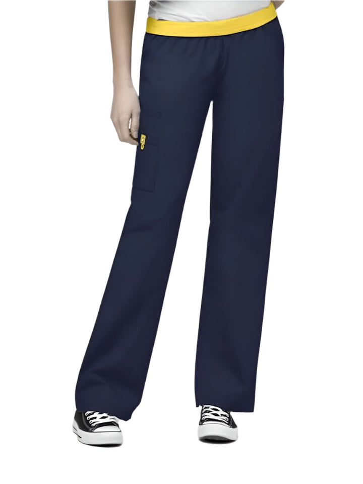 A young female Nursing Assistant wearing a pair of the WonderWink Women's Elastic Waist Quebec Scrub Pants in Navy size Medium Petite featuring a soft poly/cotton blend.