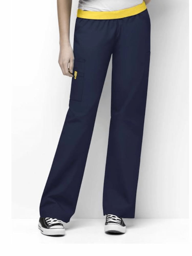 A young female Nursing Assistant wearing a pair of the WonderWink Women's Elastic Waist Quebec Scrub Pants in Navy size Medium Petite featuring a soft poly/cotton blend.