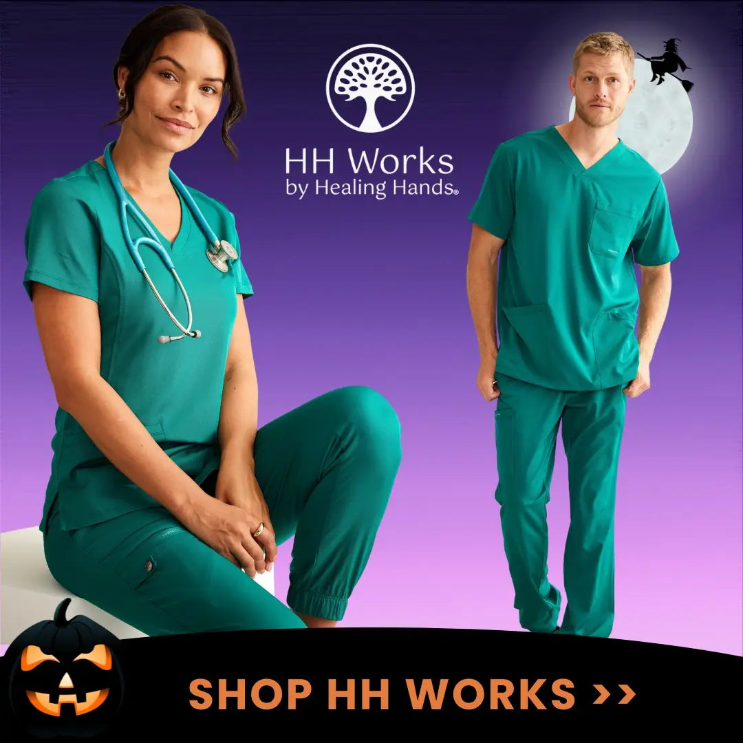 Two young surgeons displaying some of the available scrub styles in Scrub Pro's collection of HH Works scrubs on a purple Halloween-themed background.