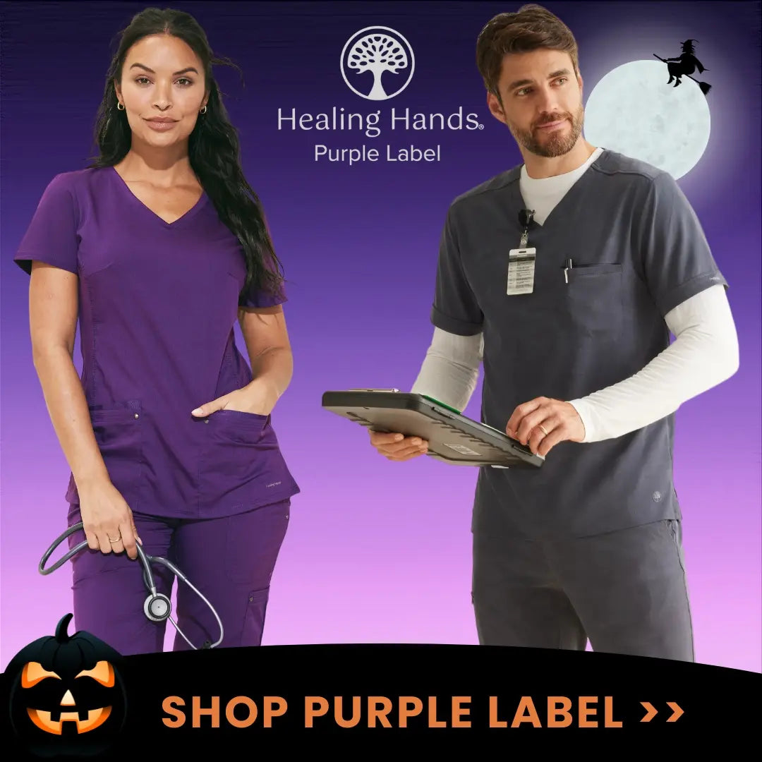 Two young Lab Techs displaying some of the available styles in Scrub Pro's collection of Purple Label Scrubs from Healing Hands.